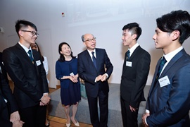 The Secretary for Transport and Housing, Mr Frank Chan Fan (centre) learned from students about their internship experiences.